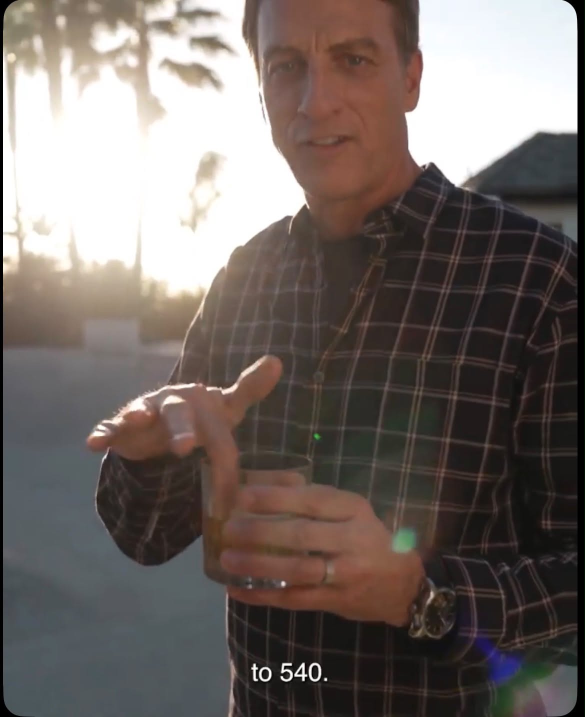 Tony Hawk holding a glass for the Flaviar Father's Day campaign