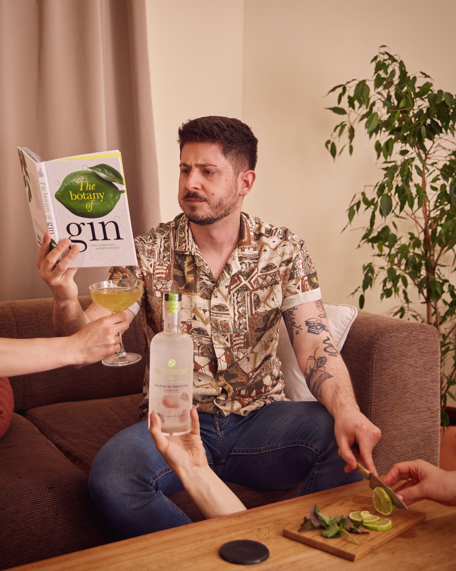 Vito on a couch with a gin in hand